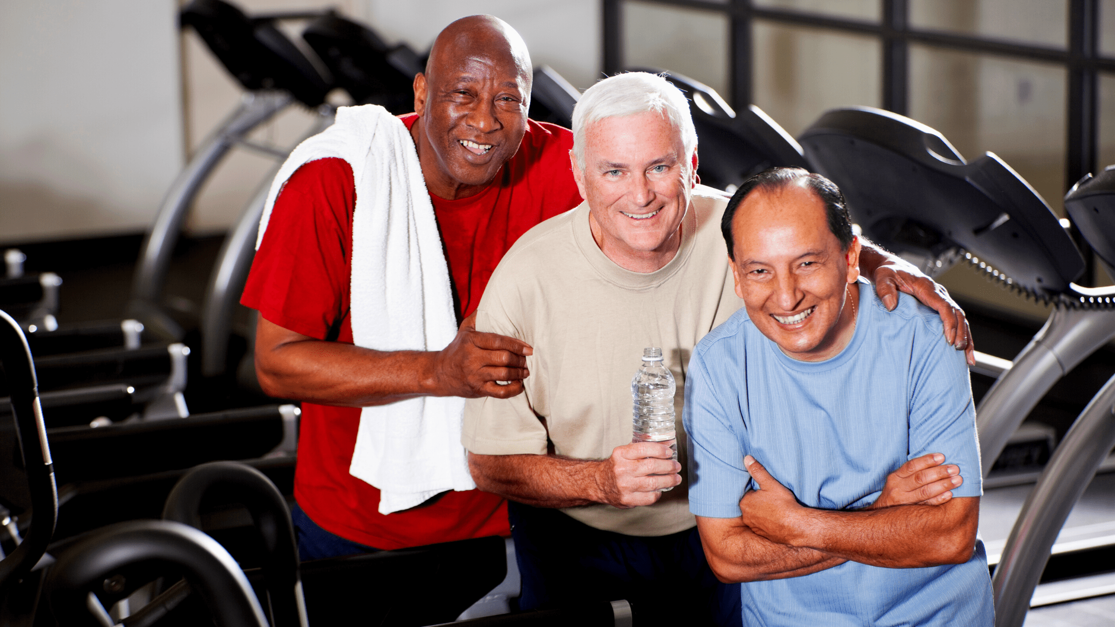 A three active aging men in the gym