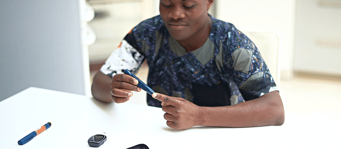 Black man checking his blood sugar level.
